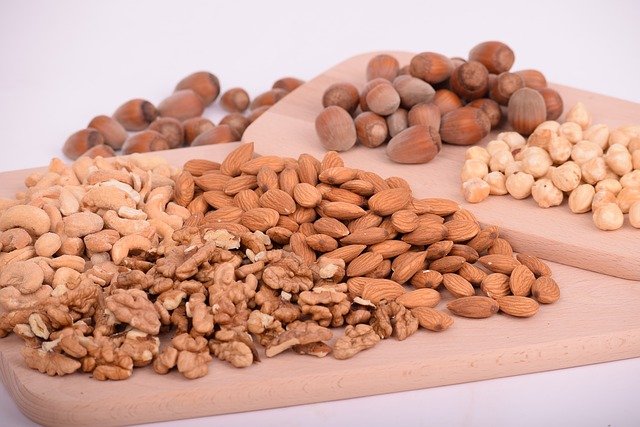 Five different types of nuts on cutting boards
